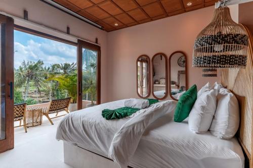 a bedroom with a bed and a large window at Woywoy Escape Tabo - Adults Only in Ubud