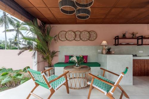 a patio with a table and two chairs at Woywoy Escape Tabo - Adults Only in Ubud