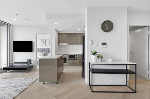 a kitchen with a table and a counter top at Modern Renovated CBD Apartment in Canberra