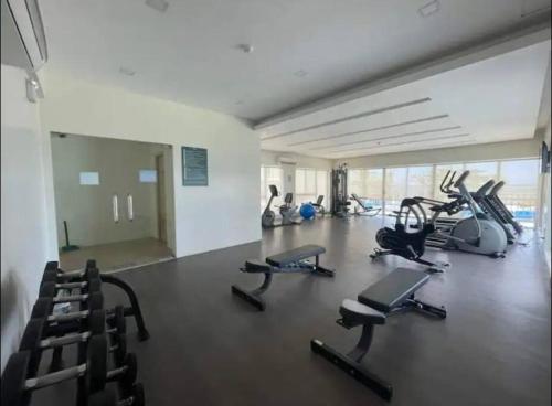 a gym with several treadmills and cardio machines at DaLei 2-330 Sleeps 8pax at Marina Spatial Condominium in Dumaguete City in Dumaguete