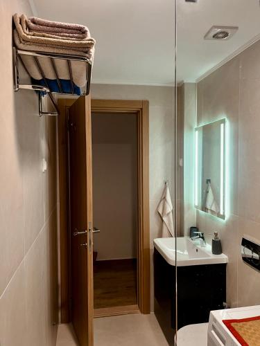 a bathroom with a sink and a glass door at Lavender Apartment - Close to the Beach - Private Garage Parking in Dobra Voda