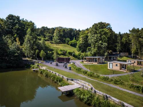 an aerial view of a river with houses at Falkensteiner Premium Camping Lake Blagus in Sveti Jurij ob Ščavnici