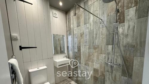 a bathroom with a shower and a toilet and a sink at Beach Lookout - Direct Beach Access - No Guest Fee in Kent