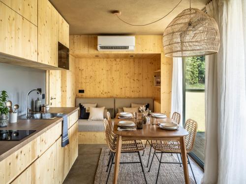 a kitchen and dining room with a table and chairs at Falkensteiner Premium Camping Lake Blagus in Sveti Jurij ob Ščavnici