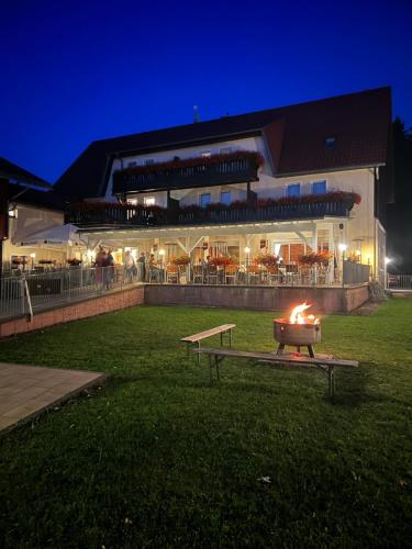 a fire pit in front of a building at night at Hotel und Berggasthof Tanzbuche in Friedrichroda