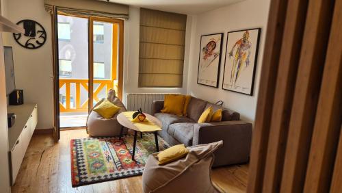 a living room with a couch and a table at Private Apartment Dado - Aparthotel Vučko in Jahorina