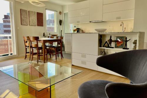 une cuisine et une salle à manger avec une table en verre dans l'établissement Apartment for 2 with balcony in Paris, à Paris