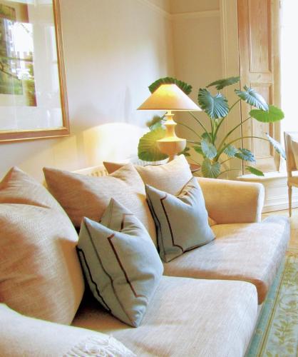 a couch with pillows on it in a living room at Crouch End Apartment - Spacious flat close to Central London in London