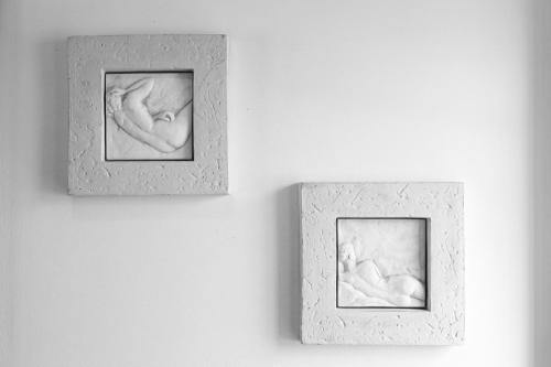 two pictures of two newborn babies on a wall at Casa do Limoeiro in Praia da Areia Branca