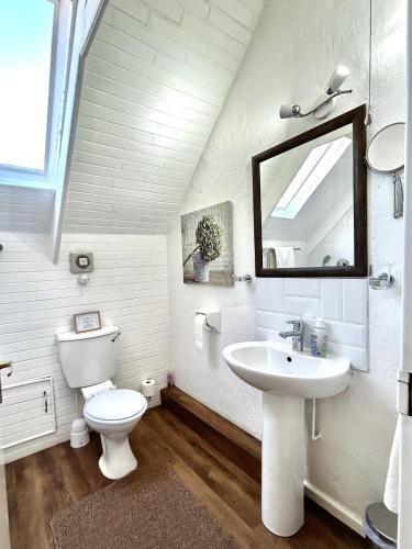 a white bathroom with a sink and a toilet at Galashiels in Dullstroom