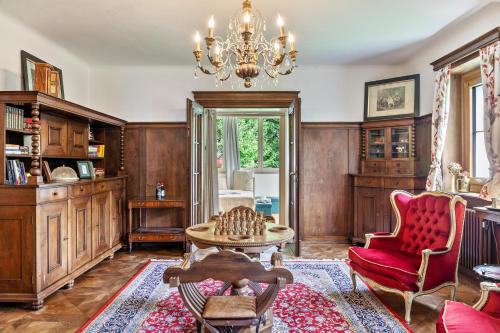 a living room with wooden walls and a chandelier at Apartment Villa Stumm in Stumm