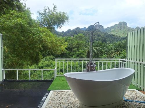 a bath tub with a faucet sitting on top at Phu Siab Mhok@KhaoSok in Khao Sok