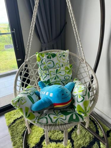 a swing chair with pillows and a blue pillow at 24'HR CHECK IN H'FLOOR SARADISE ECHELON KUCHING LUXURY BALCONY CONDO FACING AIRPORT 3R2B-2Cpark in Kuching