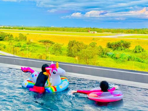 two people are riding on at 24'HR CHECK IN H'FLOOR SARADISE ECHELON KUCHING LUXURY BALCONY CONDO FACING AIRPORT 3R2B-2Cpark in Kuching