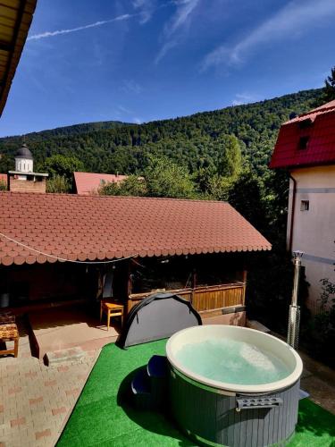 a hot tub sitting on top of a green lawn at Alpine Bliss Sinaia in Sinaia