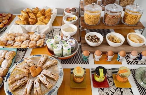 a table topped with lots of different types of food at Hotel Punta Regina in Positano