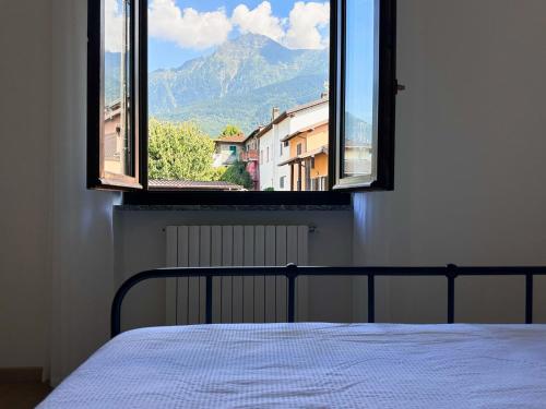a bedroom with a bed and a window with a view at Luci fra le nuvole in Colico