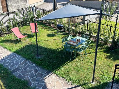 a gazebo with a table and chairs in a yard at Luci fra le nuvole in Colico