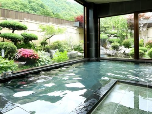 a pool in the middle of a garden at Shoji Mount Hotel - Vacation STAY 83035v in Narusawa