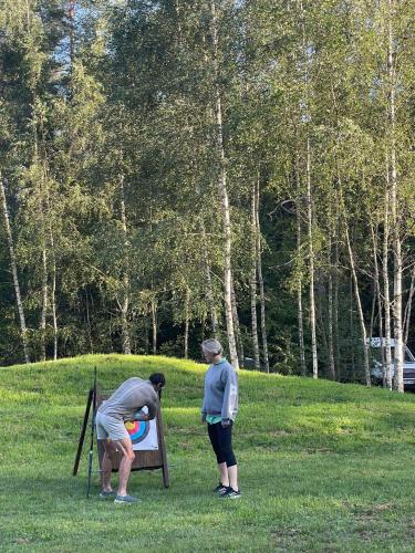 two people playing with a frisbee in a park at Homestead of Happiness in Zalioji