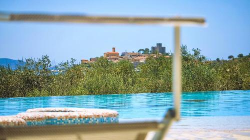 a view of a swimming pool with a house in the background at Residence with pool and private beach in Talamone just 500 mt from the sea in Talamone