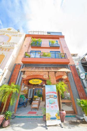 a tall building with a sign in front of it at Sujet Hotel Da Nang in Danang