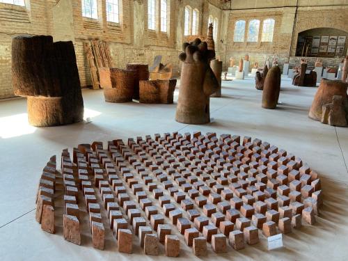 a room filled with wooden sculptures in a building at Peaceful home Suvacha in Kikinda