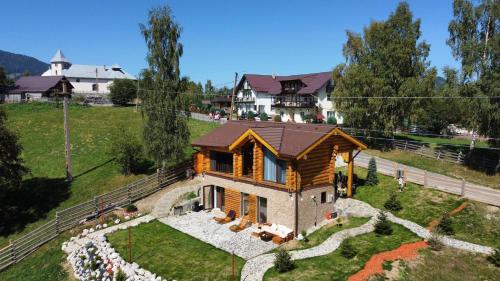 an overhead view of a log house in a field at MaviLand Chalet in Bran
