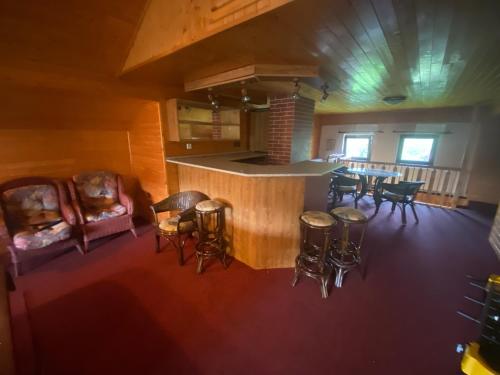 an overhead view of a room with a bar and chairs at Dům U potoka in Rudník