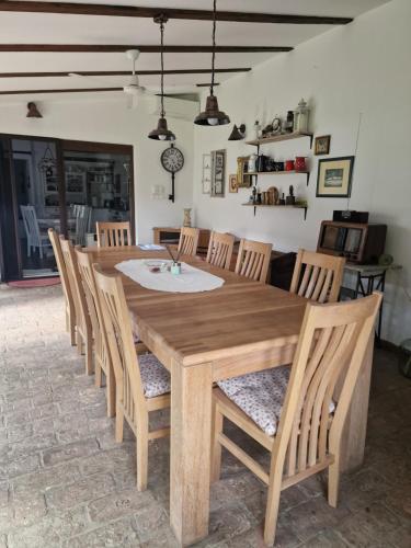a wooden dining room table with chairs and a table at Kuća za odmor Mali Princ in Karanac