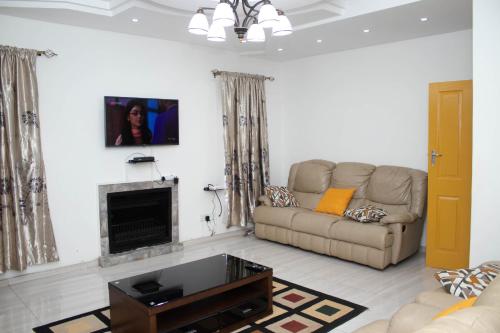 a living room with a couch and a fireplace at Pomona BB House in Harare