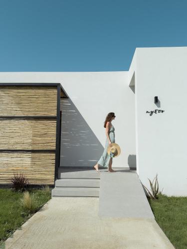 a woman walking down the stairs of a house at Aphrodite Luxury Suites with private heated pools in Kos Town