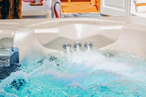 a jacuzzi tub with four faucets in it at 5 O Clock Somewhere in Bergen