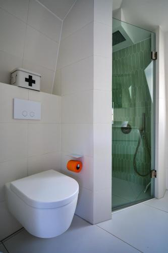 a bathroom with a toilet and a shower at 5 O Clock Somewhere in Bergen