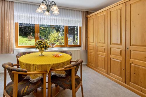 a dining room with a yellow table and chairs at Ferienwohnung Schwarzwaldglück in Lenzkirch