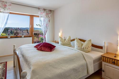 a bedroom with two beds and a large window at Ferienwohnung Schwarzwaldglück in Lenzkirch