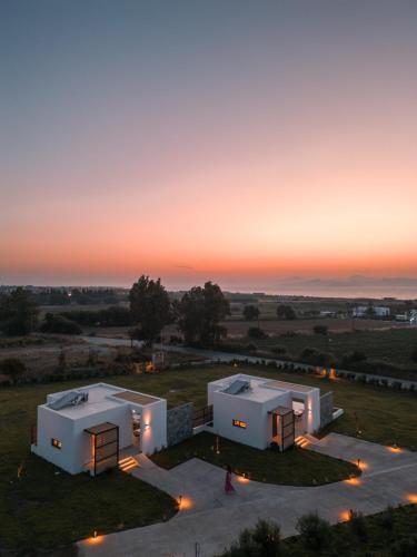 an aerial view of two white buildings at sunset at Aphrodite Luxury Suites with private heated pools in Kos Town