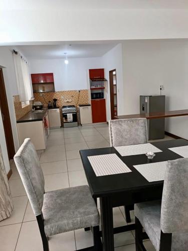 a kitchen and dining room with a table and chairs at Chelsi Homes in Shanzu