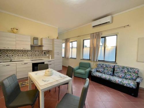 a living room with a couch and a table and chairs at The Selice Loft in Monte San Savino