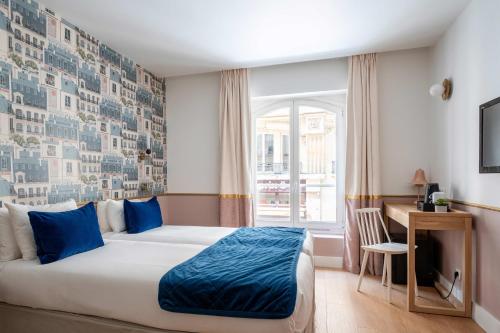 a bedroom with a bed and a desk and a window at Hotel Acadia - Astotel in Paris