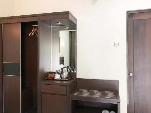 a bathroom with a sink and a mirror at Selorejo Resort Mitra RedDoorz in Sekar