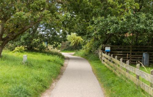 a path with a fence and trees on a field at 3 Bedroom Stunning Home In Gilleleje in Gilleleje