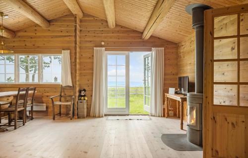 a living room with a table and chairs and a door at 3 Bedroom Stunning Home In Gilleleje in Gilleleje