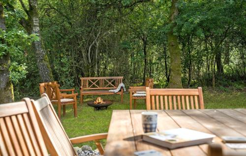 a picnic table with benches and a fire pit at 3 Bedroom Gorgeous Home In Skals in Skals