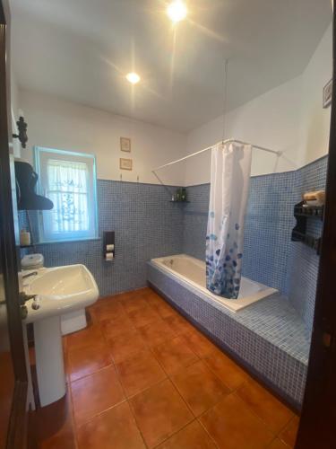 a bathroom with a shower and a sink and a tub at Casa de la playa Finisterre in Finisterre
