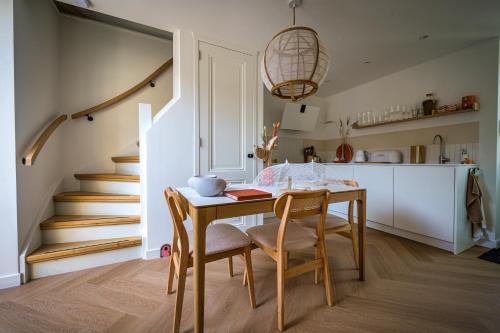 a kitchen and dining room with a table and chairs at 5 O Clock Somewhere in Bergen