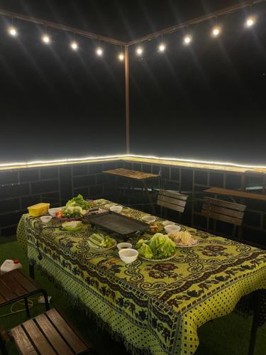 a table with food on it in a room with lights at Loop Top Đồng Văn Homestay in Dồng Văn