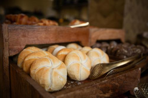 a bunch of loaves of bread on a table at Fletcher Hotel-Restaurant De Oude Gevangenis-Alkmaar in Alkmaar