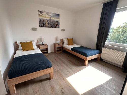 Letto o letti in una camera di Aparthotel 9 min to Dus Airport & 17 min to DUS Messe