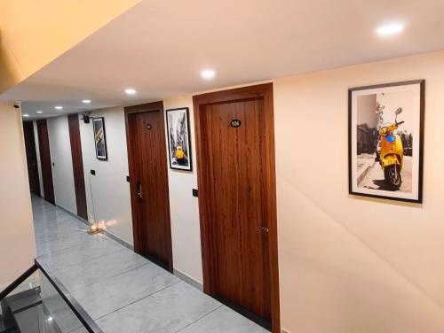 a hallway with wooden doors and a scooter on the wall at Hotel W Grand - A Boutique Hotel in Haridwār